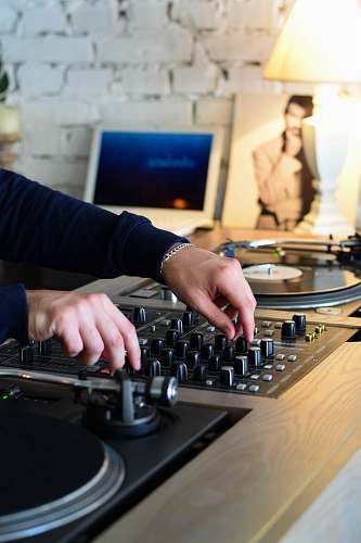 person person playing DJ mixer computer