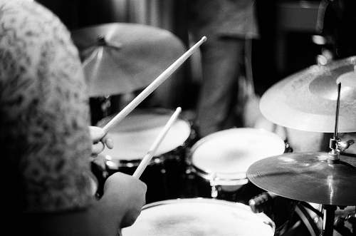 black-and-white person playing drums musical instrument