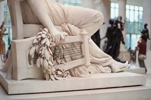 person person sitting on chair statue statue