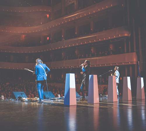 person photography of singing man on stage stage