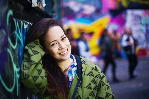 people selective focus photography of woman leaning on wall person
