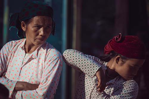 people standing girl and woman looking at right direction person