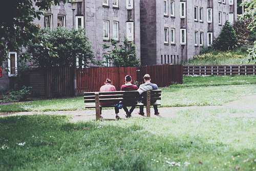person three person sitting on park bench during daytime bench
