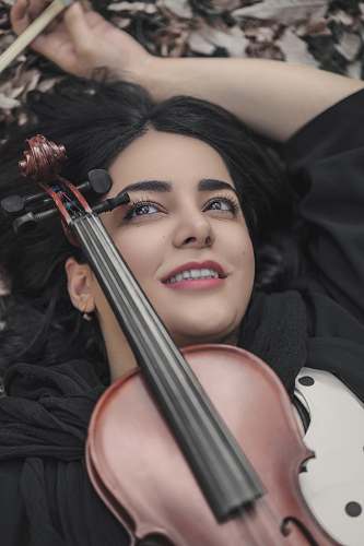 cello violin on woman's chest musical instrument
