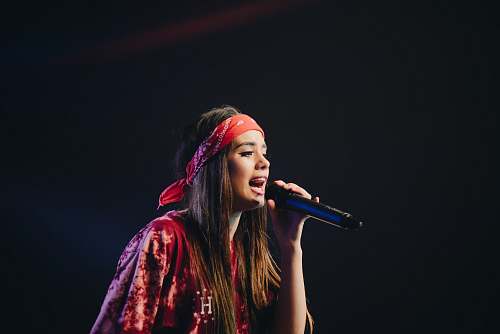 person woman in red dress holding microphone people