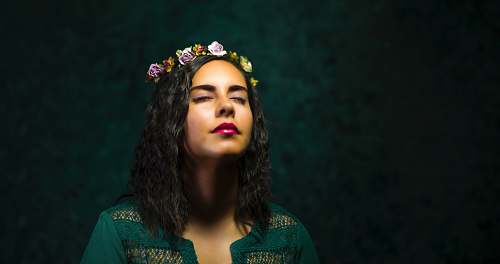 person woman in teal top with floral tiara people