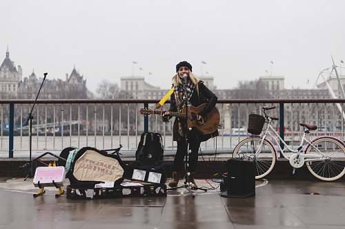 people woman playing guitar bicycle