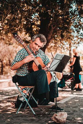 person woman playing guitar musician