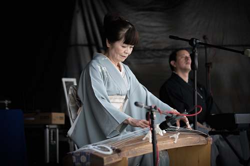 person woman playing string musical instrument apparel