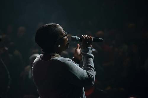 person woman singing using microphone people