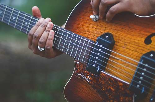 person yellow and brown electric guitar guitar