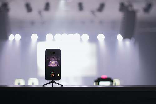 recording selective focus photography of iPhone displaying theater stage