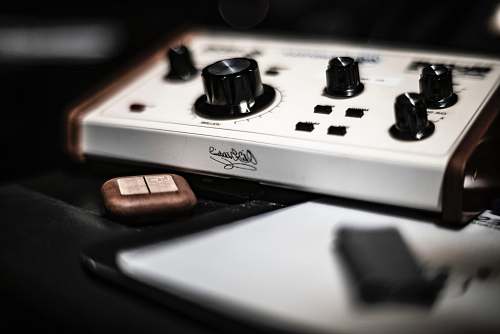 electronics shallow focus photography of control knobs coffee cup