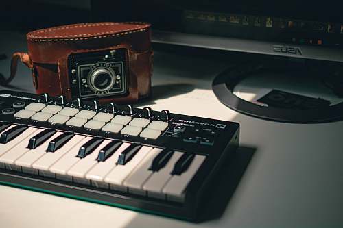 computer black electronic keyboard near black camera computer hardware