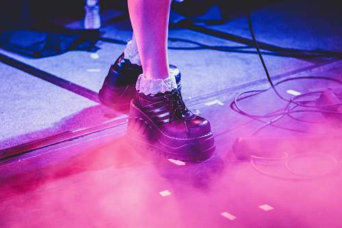 laser person wearing pair of black leather dress shoes on gray surface jar