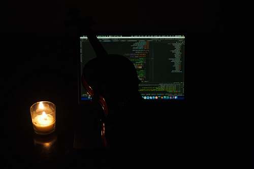 furniture black and brown violin beside lighten votive candle display