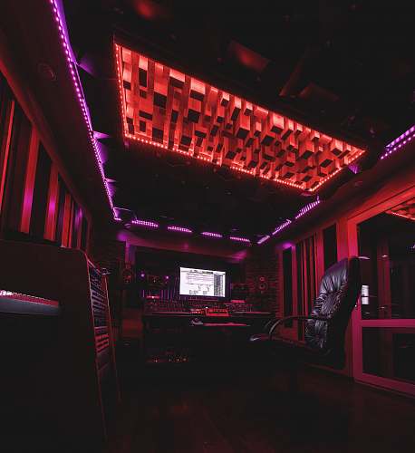 club black and silver chair near red wall night club