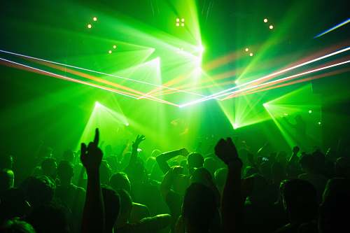club people dancing inside room with green lights night club