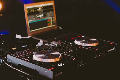 dj black DJ turn table next to laptop computer technology
