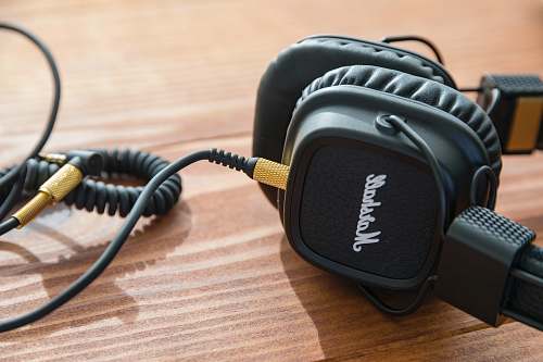 headphones black Marshall headphones on wooden table marshall
