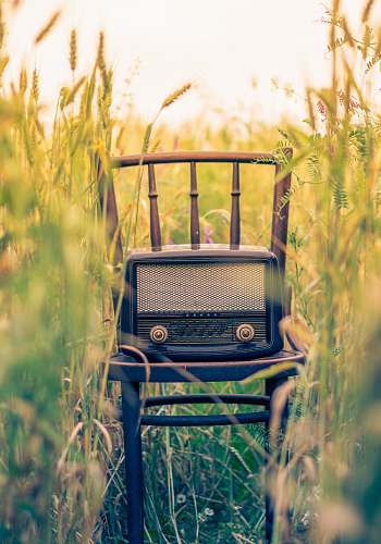 vintage black transistor radio in the middle of the field radio