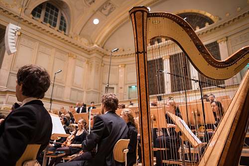 people choir in room with turned on lights harp