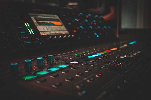 console close-up photography of turned on audio mixer electronics
