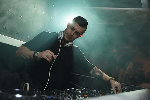 human DJ man playing song dj