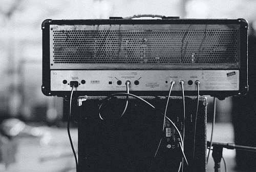 human gray and black amplifier on speaker black-and-white