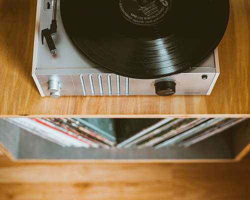 vinyl gray turntable on brown wooden table record