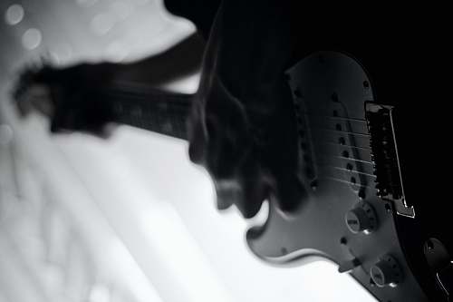 guitar grayscale photo of person playing electric guitar black-and-white