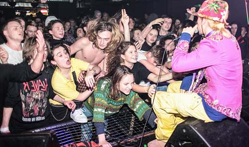 human man in pink long-sleeved top performing on stage person