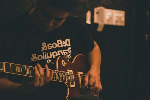 guitar man playing brown guitar musical instrument