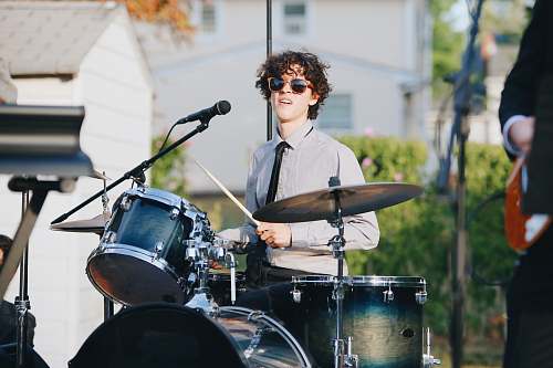 human man playing drum in street at daytime musician