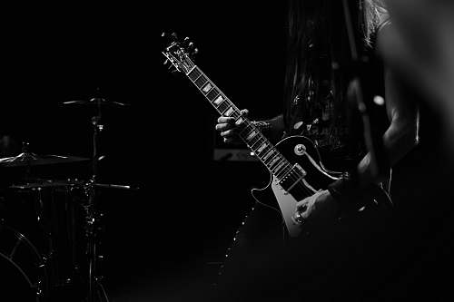 black-and-white man playing electric guitar guitarist