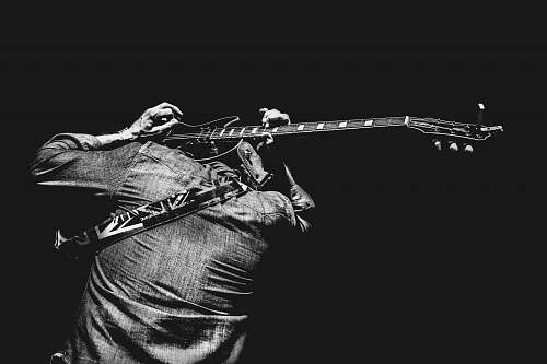 guitar man playing guitar on his back black-and-white