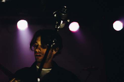 man man standing in front of microphone singer