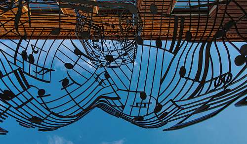 blue musical notes themed metal artwork under blue sky at daytime art