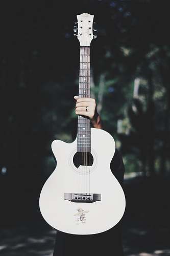guitar person holding white acoustic guitar electric guitar