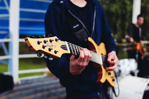 human person playing electric guitar guitar