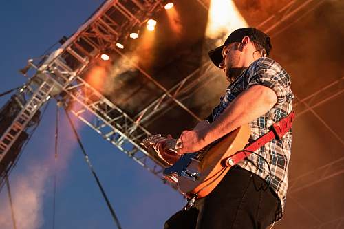 guitar person playing guitar on stage guitarist