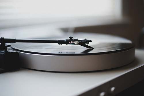 grey tilt shift lens photography of gray and black turntable record player
