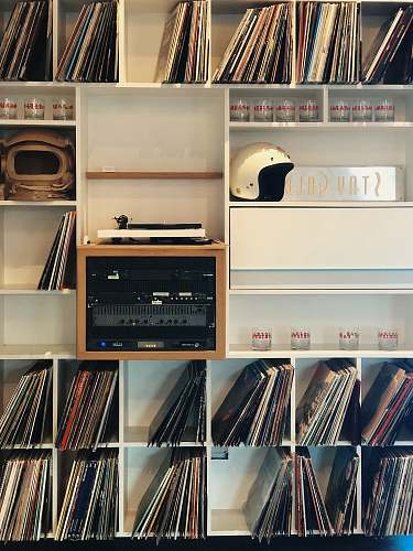 collage vinyl sleeves on white wooden cube shelf poster