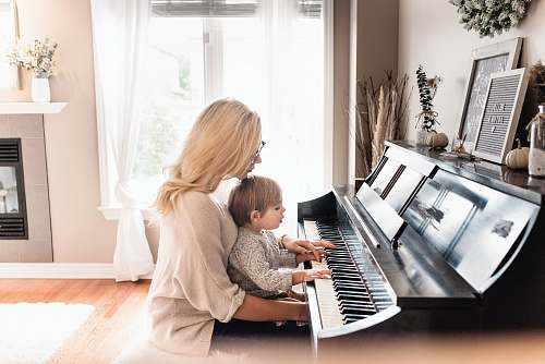 person woman and child playing piano human