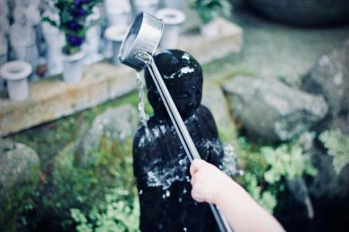 hase-dera person watering figurine during daytime kamakura-shi