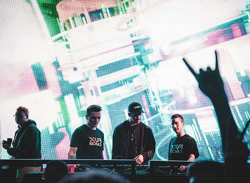 human DJ controller play on stage person