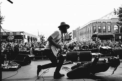 human grayscale photography of concert during daytime black-and-white