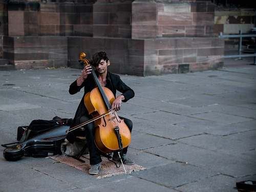 human man playing cello person