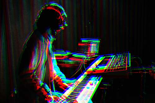 human man playing electronic keyboard person