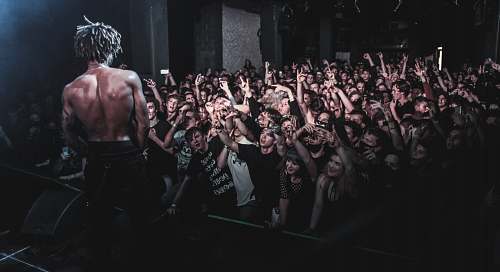 human man standing on stage crowd